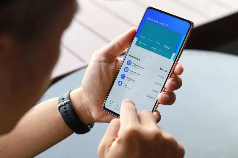 cropped image of asian man checking bank account and spending using his mobile device convenience and easy banking with technology