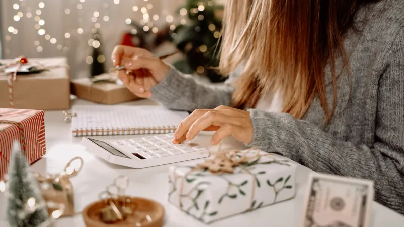 girl counting us dollar bills, using calculator, and writing expenses woman doing budget, estimating money balance for shopping spree female accountant paying taxes girl counting christmas gifts