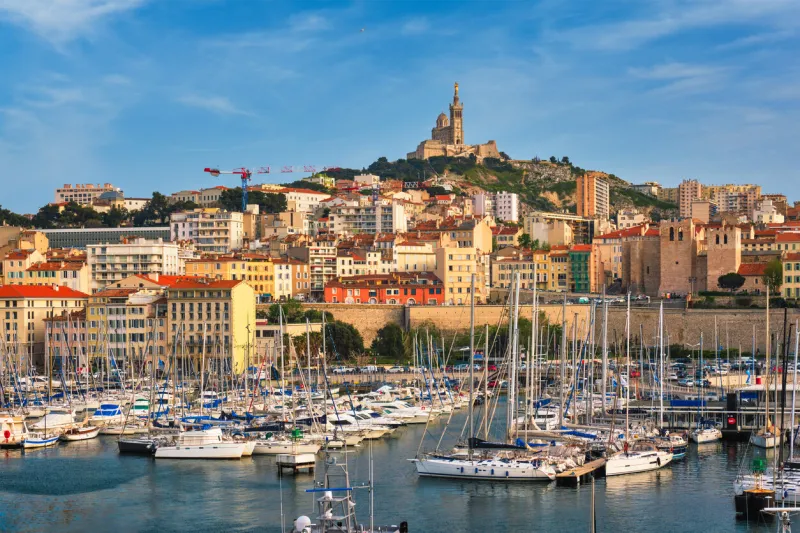 marseille old port (vieux-port de marseille) with yachts and basilica of notre-dame de la garde marseille, france