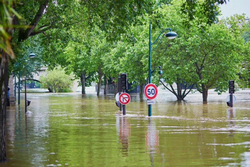 flood in paris, extremely high water on the river seine, road signs covered with water
