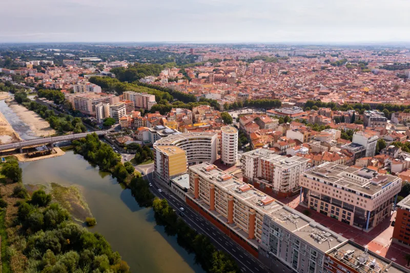 panoramic view of perpignan city center and tet river on sunny day, france