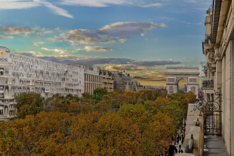 autumn colors on tree leaves on the southern side of lavenue des champs-Élysées with larc de triomphe in the background, seen from the law offices of graf notaires paris