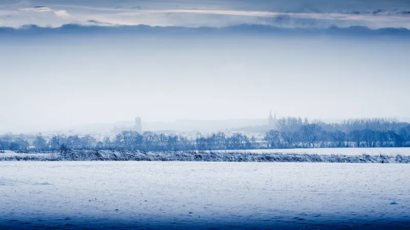 winter landscape with frozen river and town of soissons in france in the backgroundview of the cathedral and the saint jean des vignes abbey