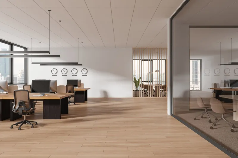 stylish business interior with coworking and glass conference room, pc computers on wooden desk and armchairs in row panoramic window on kuala lumpur skyscrapers 3d rendering