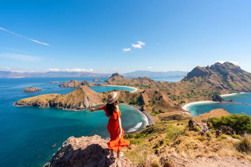 young female tourist enjoying the beautiful landscape at padar island in komodo national park, indonesia