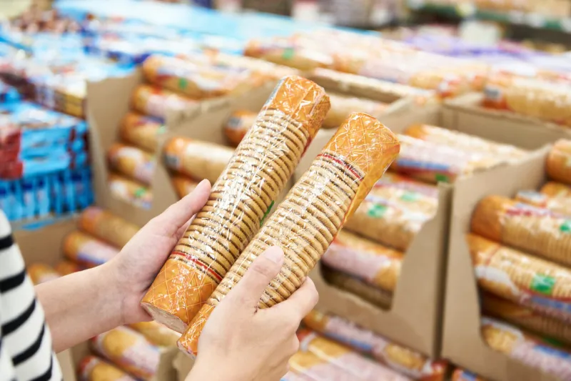 packets of biscuits in the hands of the buyer