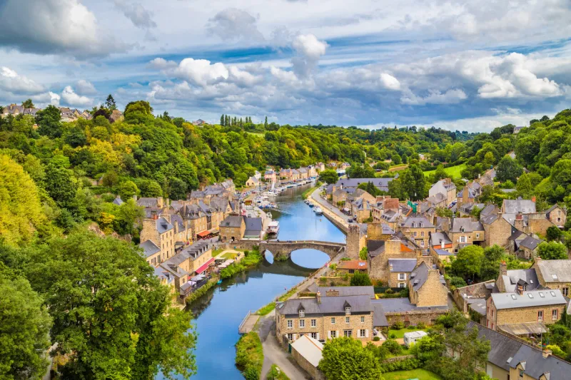 aerial view of the historic town of dinan with rance river with dramatic cloudscape, cotes-d'armor department, bretagne, northwestern france