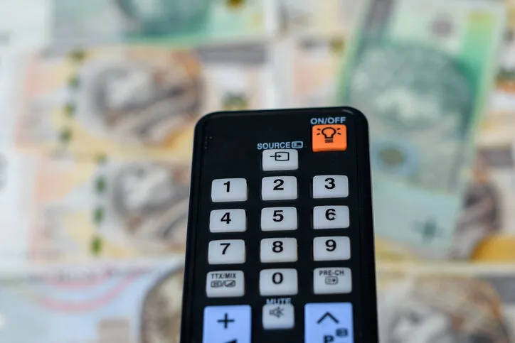 remote control for tv on a blurred background with polish pln banknotes