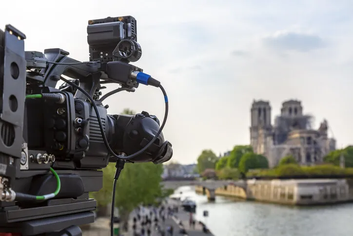 close-up image of a television professional rig broadcasting from notre dame cathedral surroundings in paris after the fire which destroyed the roof of the building on 15 april