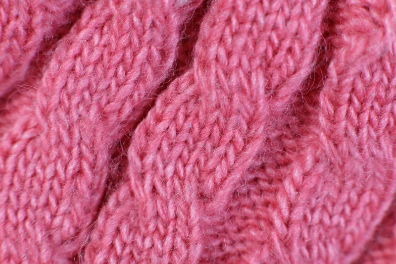 texture hand-knitted or machine knitting pattern braid fabric background close-up