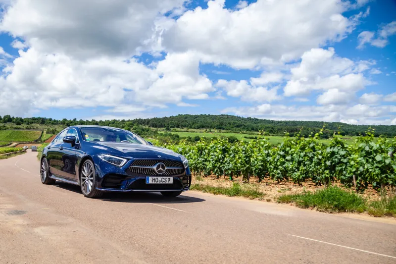 france lyon 2019-06-20 closeup front view luxury dark blue german car sedan premium mercedes cla with eu registration number on road at french vineyards concept wine travel in beaune, burgundy