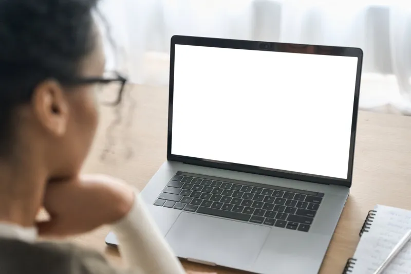 over shoulder closeup view of female student wearing glasses businesswoman looking at empty blank mockup screen for advertising, having virtual videoconference remote e learning online work concept