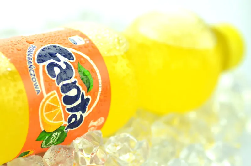 kwidzyn, poland - may 26, 2014  bottle of fanta drink on ice cubes fanta is fruit-flavored carbonated soft drink produced by coca-cola company fanta was introduced in