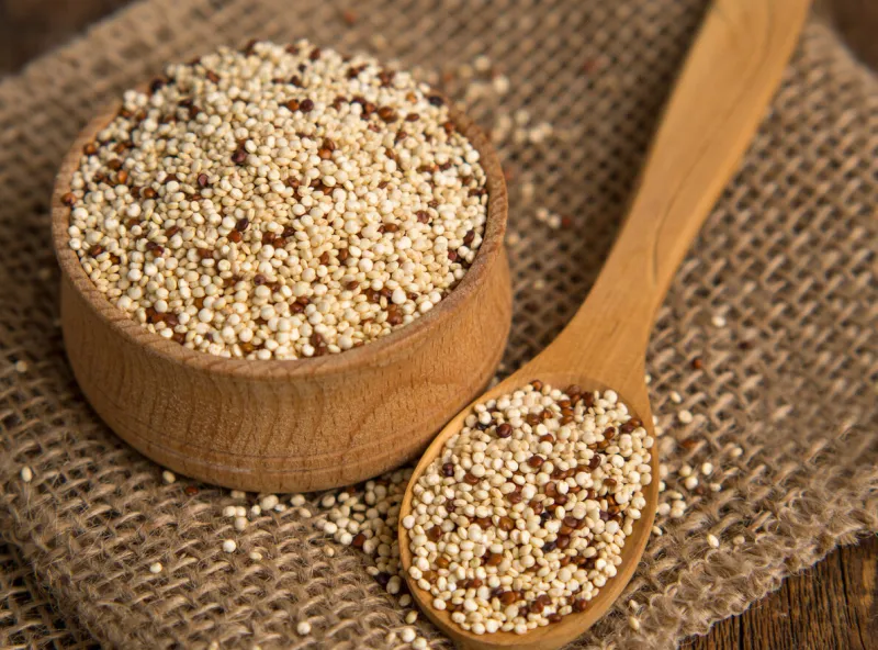 mixed raw quinoa in bowls on a wooden background healthy and gluten free food