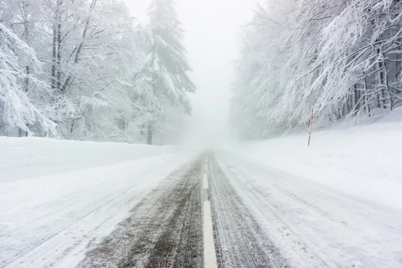 a snowy and icy road in the vosges mountains (france) in winter