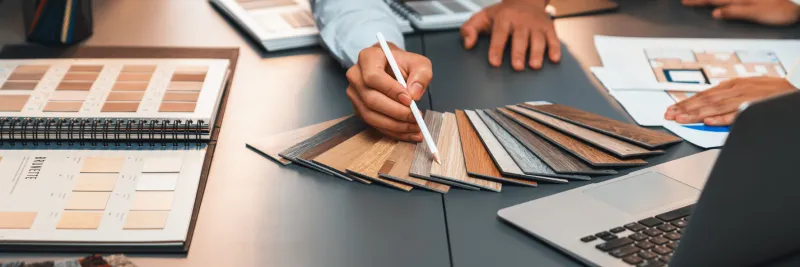 group of interior designer team in meeting, discussing with engineer on interior design and planning for house project blueprint and model, choosing various mood board materials insight