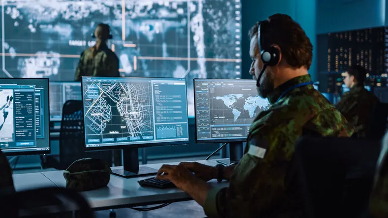 military surveillance officer working on a city tracking operation in a central office hub for cyber control and monitoring for managing national security, technology and army communications