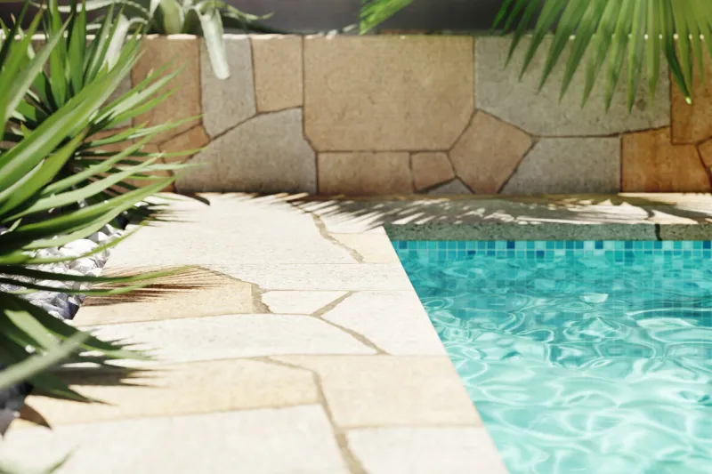 luxury swimming pool with tropical plants and stone path poolside patio in mediterranean holiday villa