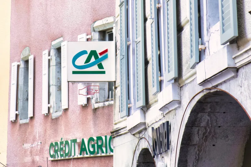 thones, france - 03 september 2022 the sign of a french bank, the credit agricole, is hanging above an historic village office