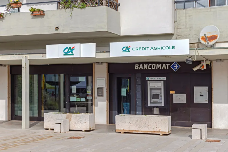 treporti, italy - october 09, 2024  french bank credit agricole building at square giovanni paolo ii sunny fall day
