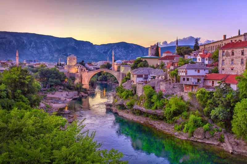 the neretva river winding through the old unesco listed, mostar bridge in bosnia and herzegovina