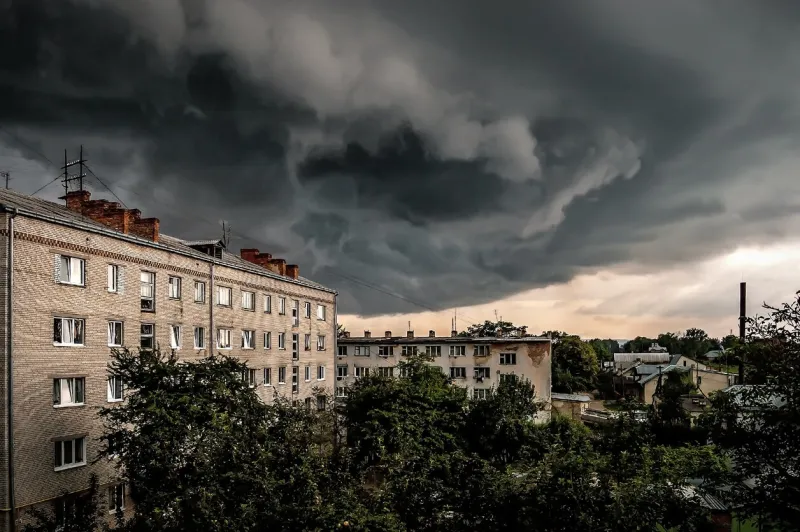 amazing dark stormy tornado clouds over the apartment building in the city