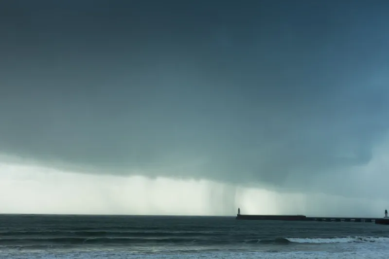stormy weather with rain clouds and lighthouse in the sable d'olonne in france
