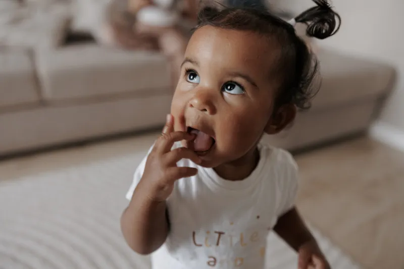portrait of mixed race toddler girl in room afro-caucasian little girl concept of interracial family