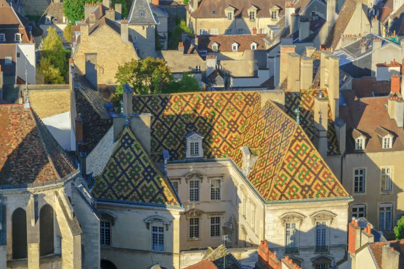an aerial view of the historic center of the city, with a colored patterned roof, in dijon, burgundy, france