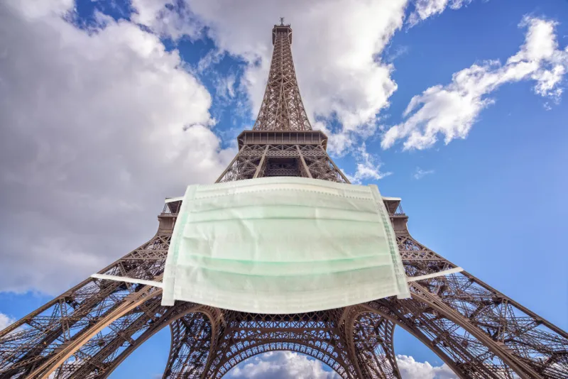eiffel tower wearing a surgical mask new coronavirus, covid-19 in paris france epidemic crisis concept