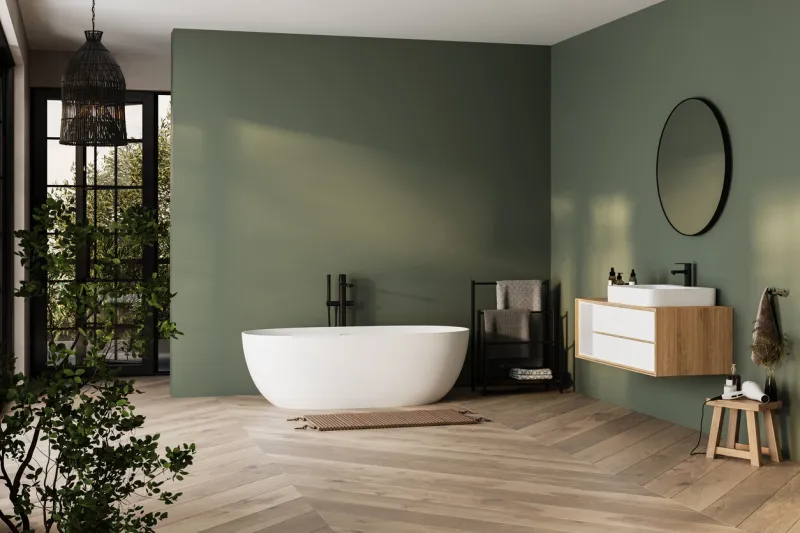 modern minimalist bathroom interior, bathtub and bathroom cabinet, white sink, interior plants, bathroom accessories, parquet floor, green wall