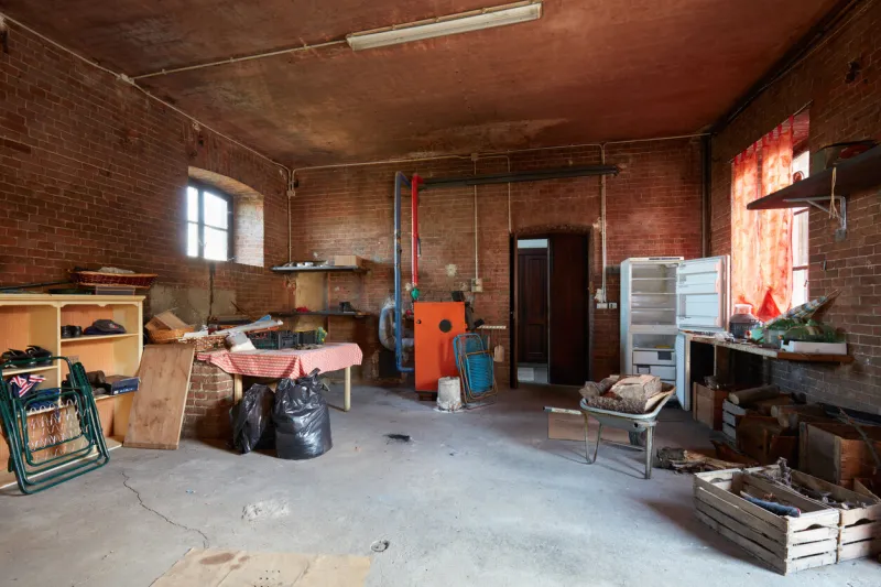 messy basement with red bricks walls in old country house