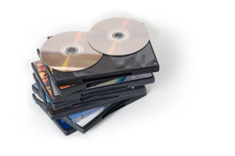 a pile of dvd cases with dvds on top