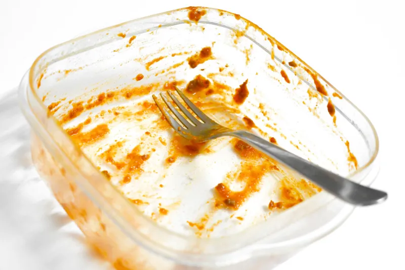 dirty food plastic box and fork unclean dishes