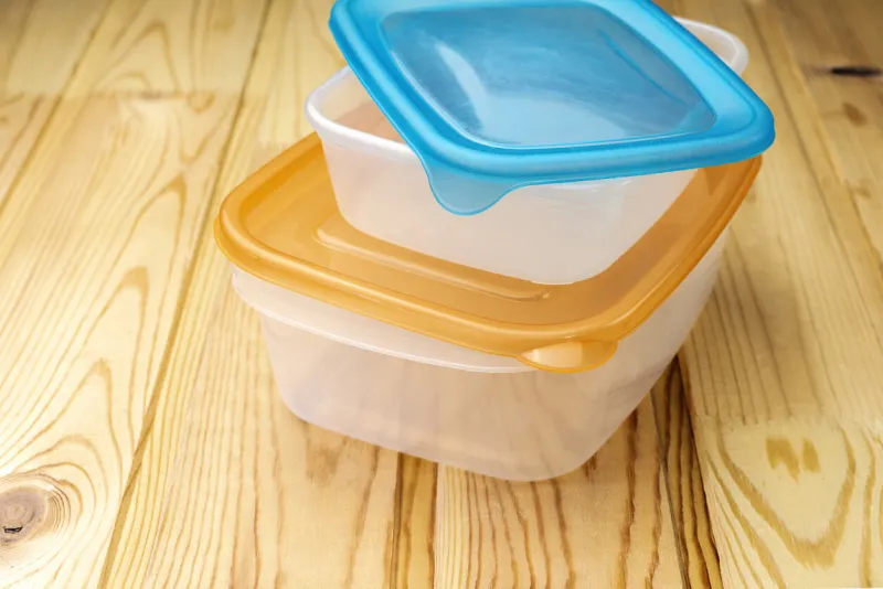 plastic food containers on a wooden table