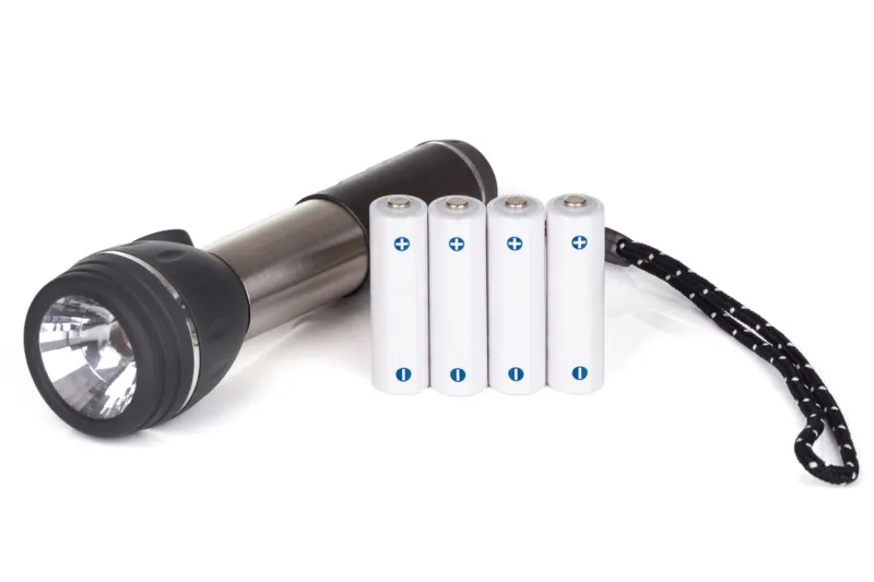 flaslight with batteries over white background