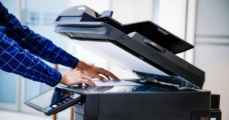 businessmen press button on the panel for using photocopier or printer for printout and scanning document paper at office