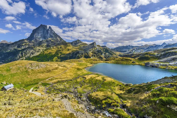 view at midi ossau mountain peak and lake roumassot, in ayous-bious valley in french atlantic pyrenees, as seen in october aquitaine, france