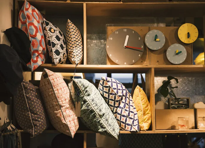 pillows and handmade clocks in an elegant shop