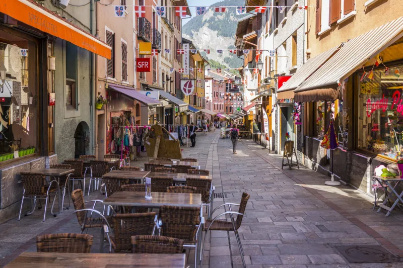 bourg-saint-maurice, france - august 29, 2015  the main street of the old town with shops and tourists bourg-saint-maurice france