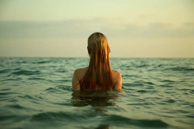 the girl swiming in sea waves an art photo a beautiful landscape