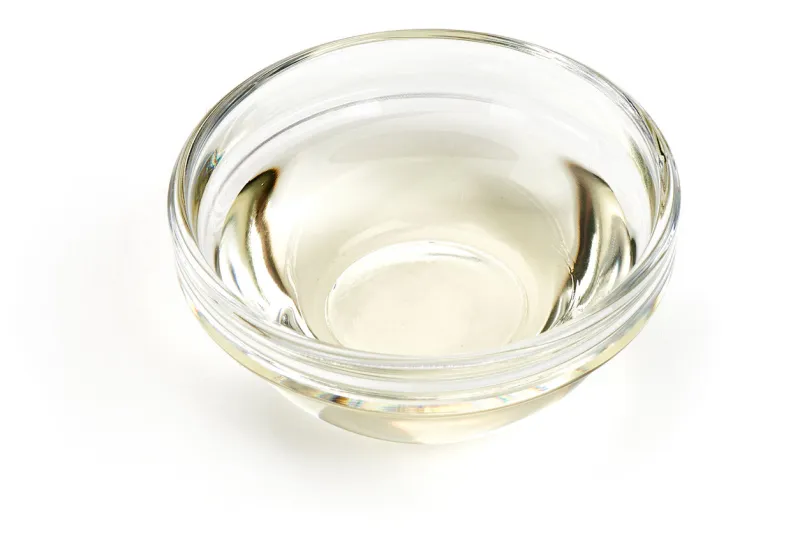 white vinegar in a glass bowl, isolated on white background top view