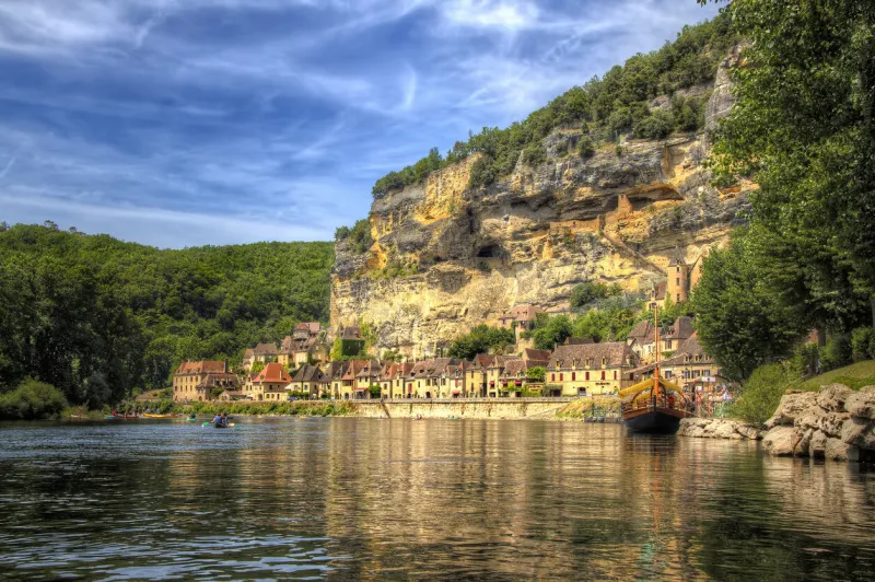 river dordogne passing roque gageac, one of the most beautiful villages in france