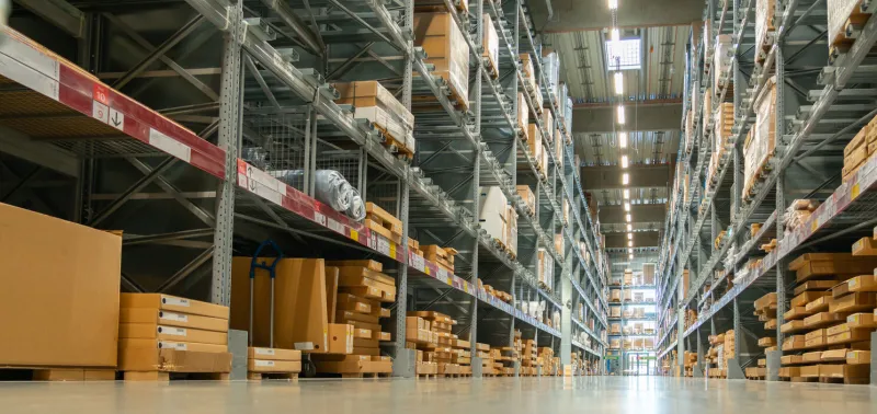 panoramic view of a large warehouse in the aisle between shelves and racks
