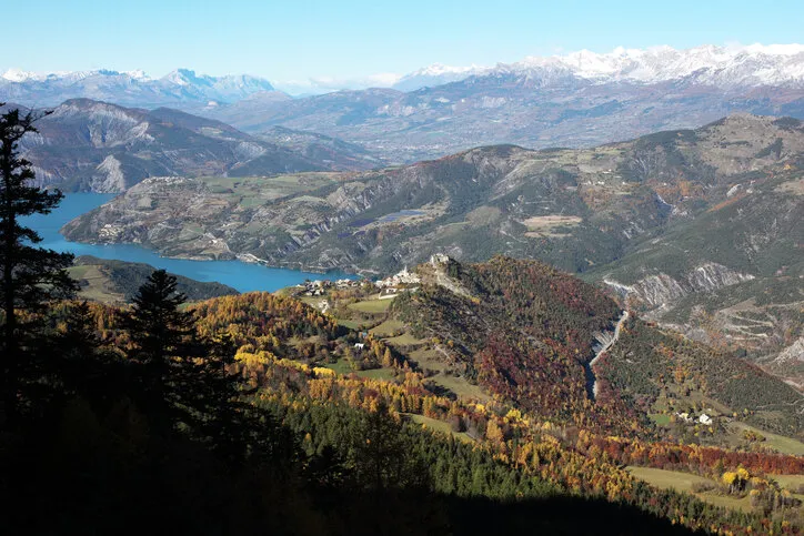 the village of saint-vincent-les forts dominates the ubayenne branch of lake serre-ponçonthe image is taken from the path which leads to dormillouse, at 1650m altitude, in a north-northwest direction