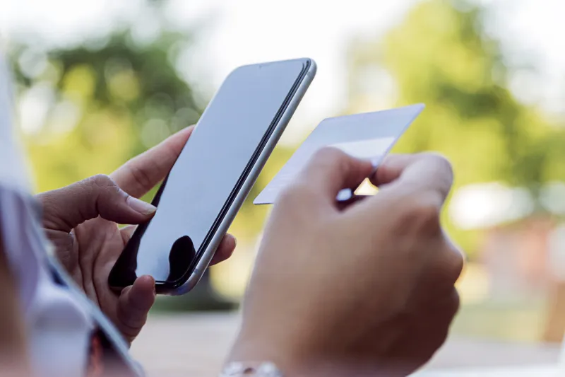 online payment,woman's holding smartphone and using credit card for online shopping woman is shopping online with cell phone