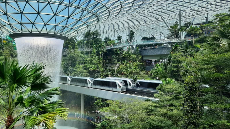 sky trains passing roof waterfall at jewel area, terminal 1, changi airport, singapore on january 26, 2020, rain vortex