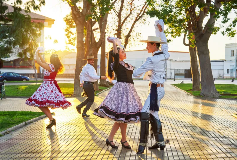 young couples dressed as huasos dance cueca celebrating the national holidays in the city square