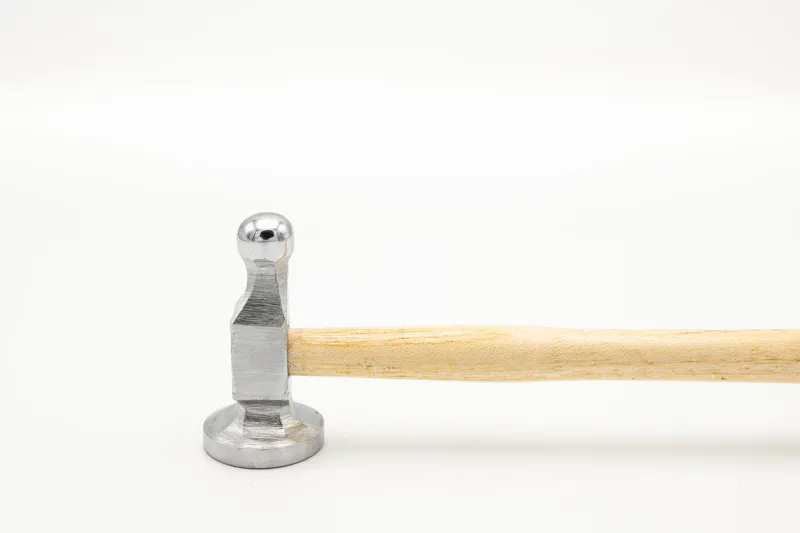 closeup of a chasing hammer lying on a white background