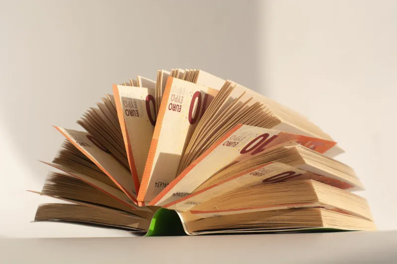 books with nested euro banknotes, isolated on white stash of money